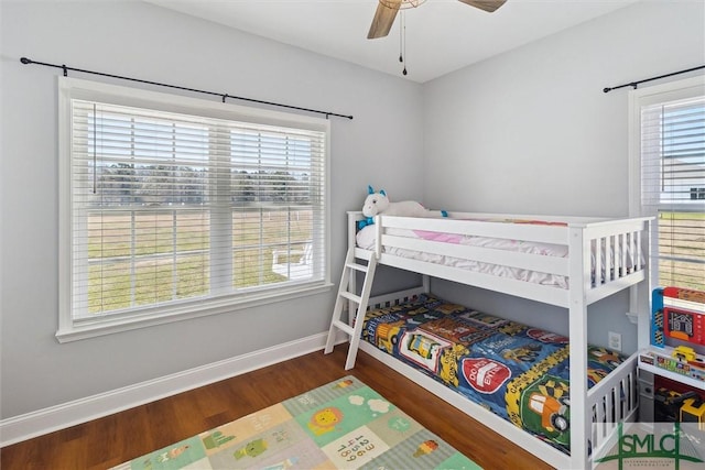 bedroom with wood finished floors, a ceiling fan, and baseboards