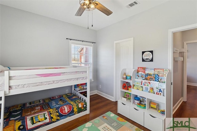 bedroom featuring baseboards, visible vents, and wood finished floors