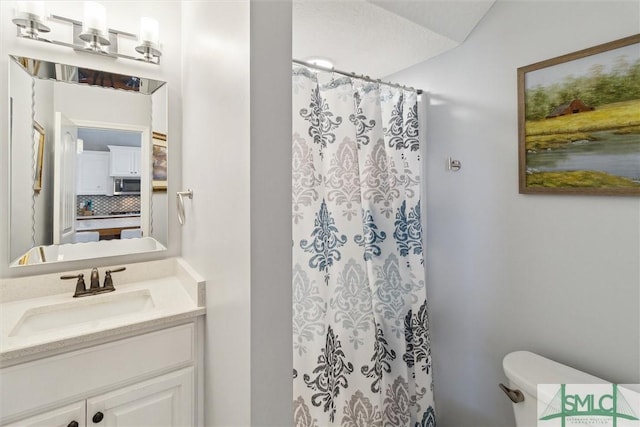 full bathroom with toilet, curtained shower, and vanity