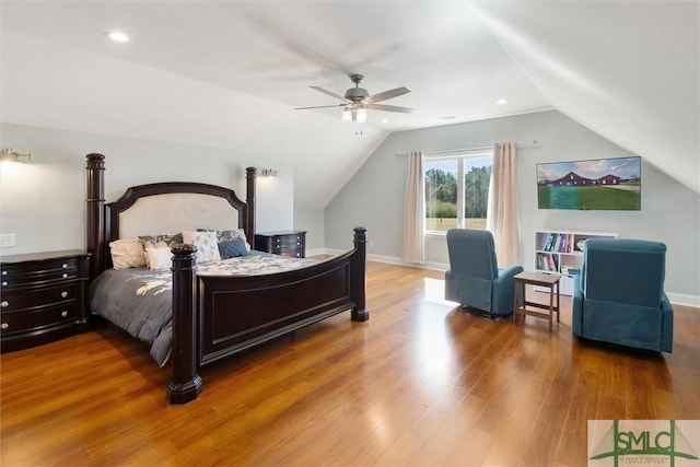 bedroom featuring lofted ceiling, wood finished floors, a ceiling fan, and baseboards