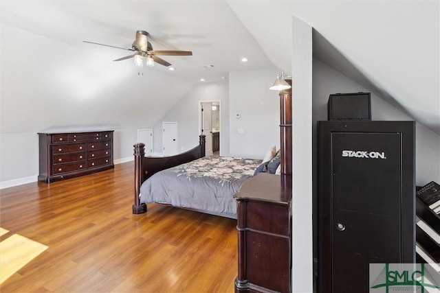 bedroom featuring ceiling fan, vaulted ceiling, baseboards, and wood finished floors