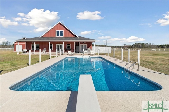 view of swimming pool featuring a fenced in pool, a patio, french doors, fence, and a yard