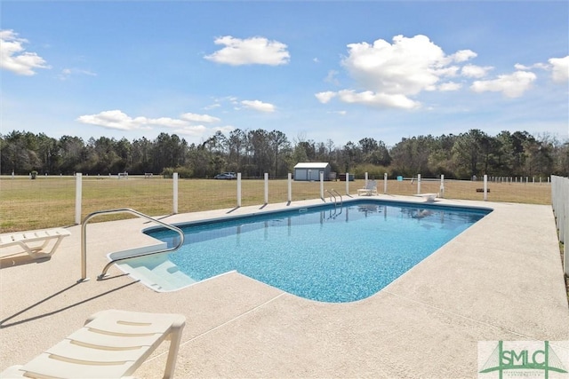 view of swimming pool with a patio area, fence, a fenced in pool, and a yard