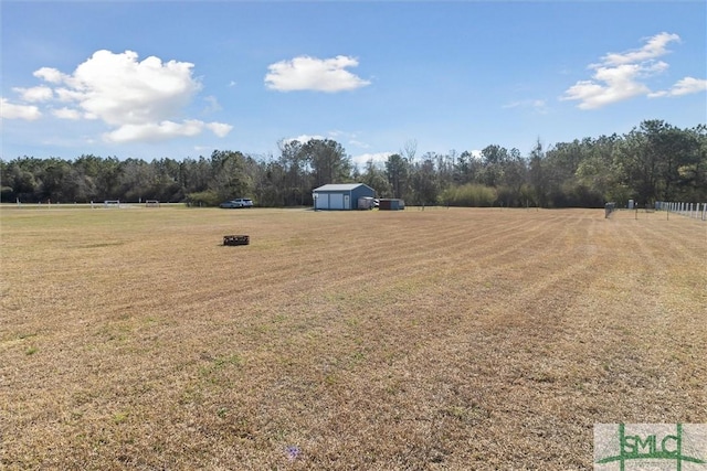 view of yard featuring a rural view and an outbuilding