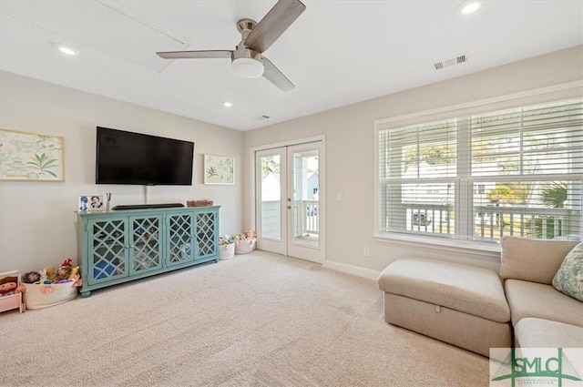 carpeted living area featuring recessed lighting, visible vents, baseboards, and french doors