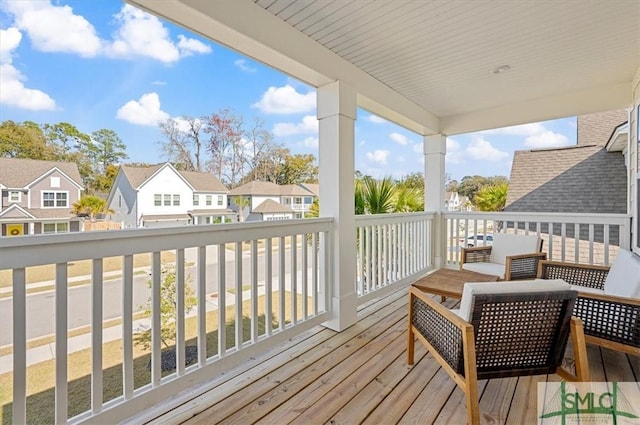 wooden terrace featuring a residential view