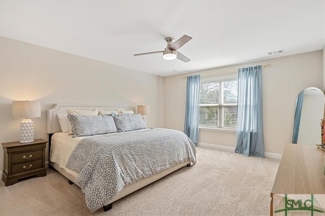 bedroom featuring light carpet, baseboards, visible vents, and ceiling fan