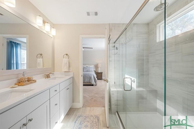 ensuite bathroom with a stall shower, a sink, and ensuite bath