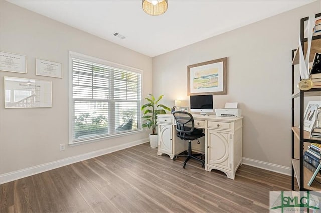 office featuring baseboards, visible vents, and light wood-style flooring