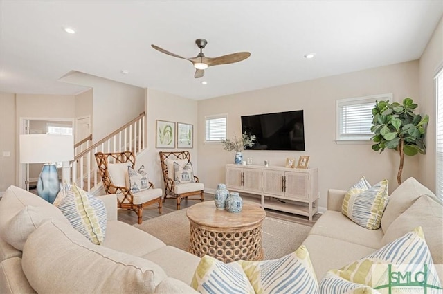 living room with baseboards, a ceiling fan, wood finished floors, stairs, and recessed lighting