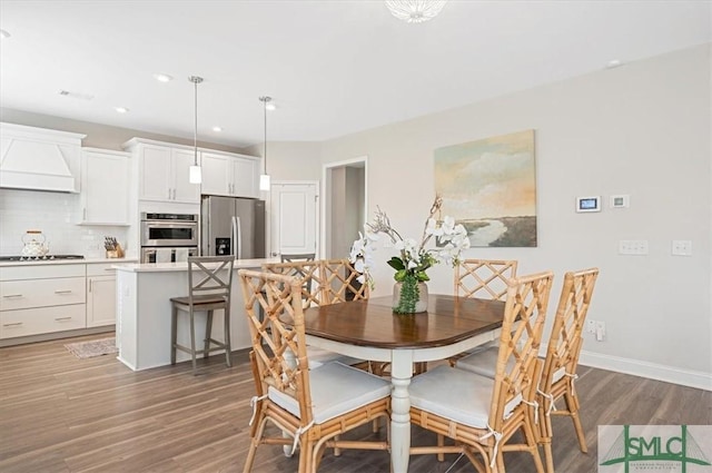 dining space with visible vents, baseboards, wood finished floors, and recessed lighting