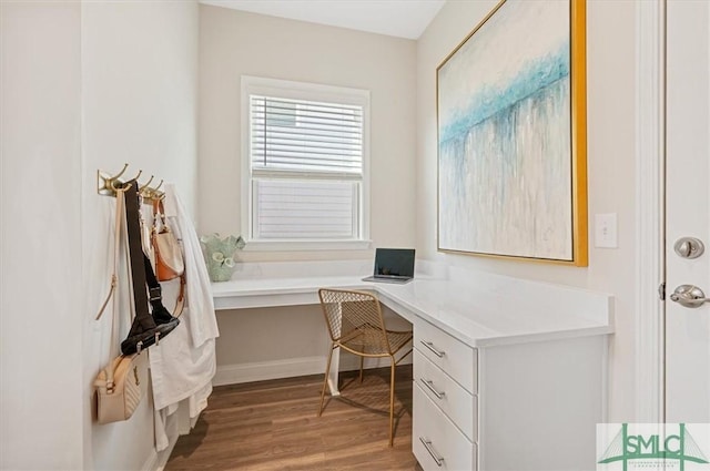 office area featuring built in desk and wood finished floors