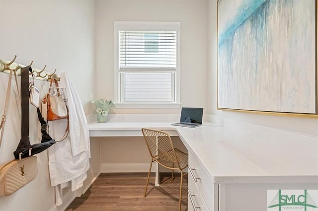 office space with built in desk and wood finished floors