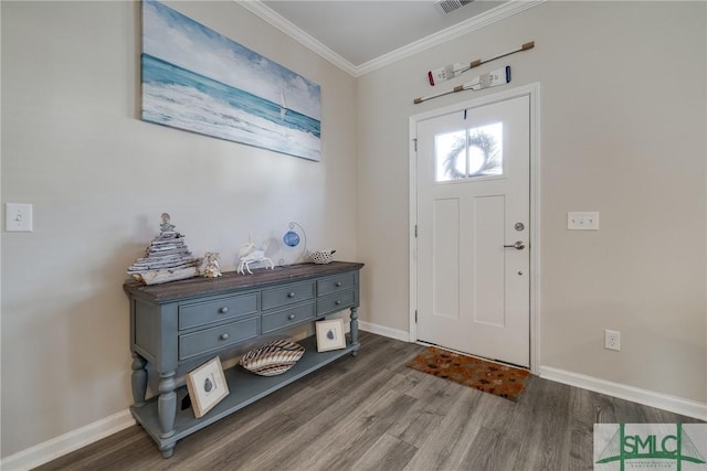 foyer with ornamental molding, baseboards, and wood finished floors