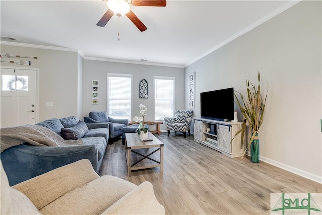 living area with baseboards, ornamental molding, visible vents, and light wood-style floors