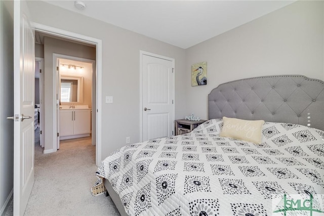 bedroom with light colored carpet, a sink, and baseboards