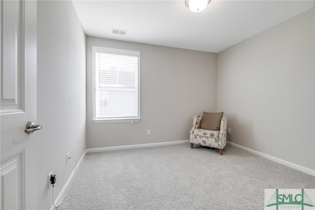 unfurnished room featuring carpet floors, visible vents, and baseboards