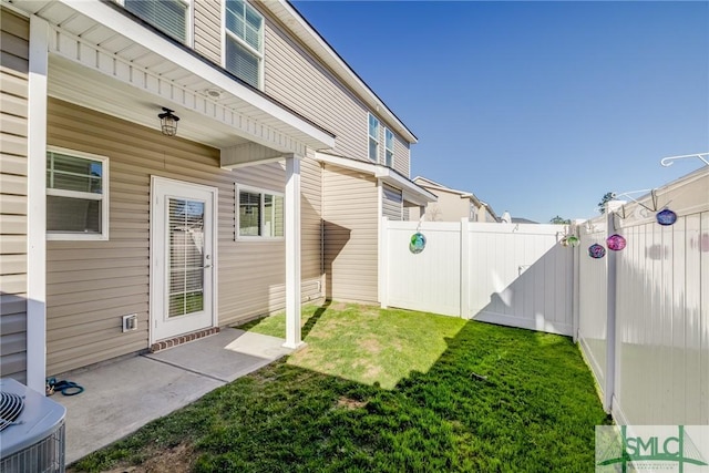 view of yard featuring a fenced backyard, central AC, and a patio