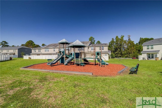 communal playground featuring a residential view and a yard