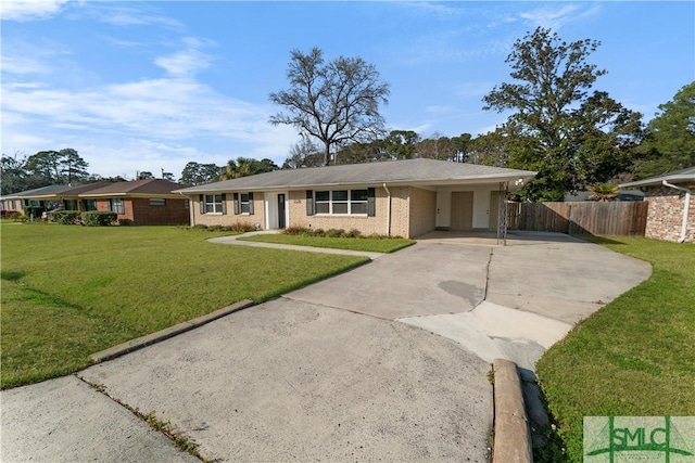 ranch-style house featuring brick siding, a front lawn, driveway, and fence