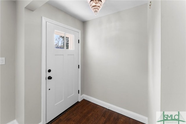 foyer entrance featuring dark wood-type flooring and baseboards