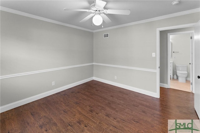 unfurnished room with visible vents, dark wood-style floors, and ornamental molding