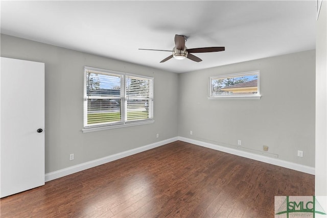 empty room featuring a ceiling fan, wood finished floors, and baseboards