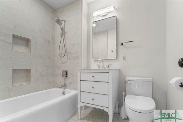 bathroom with vanity, bathing tub / shower combination, toilet, and speckled floor