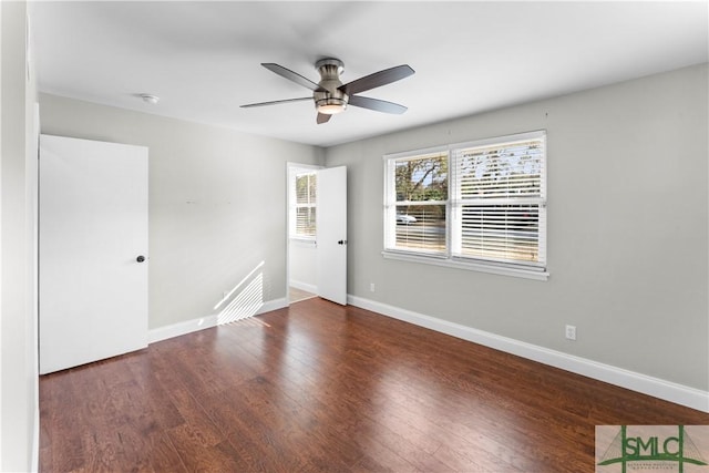 spare room with a ceiling fan, baseboards, and wood finished floors