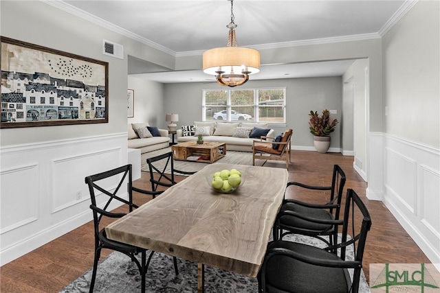 dining room with visible vents, wainscoting, dark wood-style flooring, and crown molding