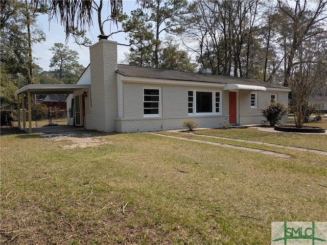 view of front facade featuring a carport, brick siding, a chimney, and a front lawn