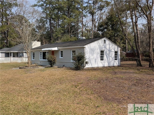 single story home with a chimney, a front lawn, and fence