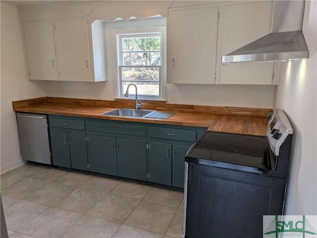 kitchen featuring butcher block countertops, electric stove, a sink, wall chimney exhaust hood, and dishwasher