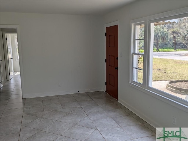 interior space featuring plenty of natural light, baseboards, and light tile patterned floors