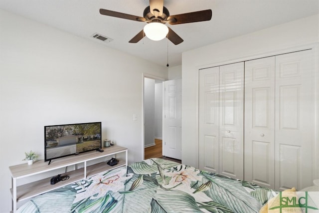 bedroom with visible vents, a closet, and ceiling fan