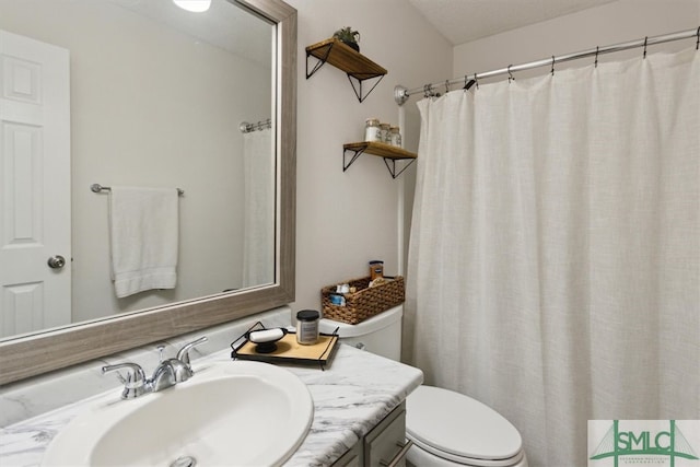 bathroom with vanity, curtained shower, and toilet