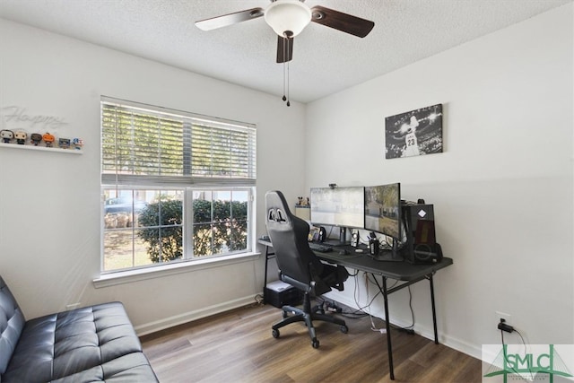 office with a ceiling fan, wood finished floors, baseboards, and a textured ceiling