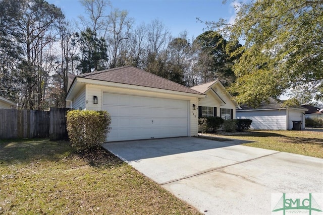 ranch-style house with a front lawn, concrete driveway, fence, and a garage