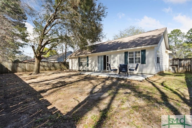 back of property with a patio and a fenced backyard