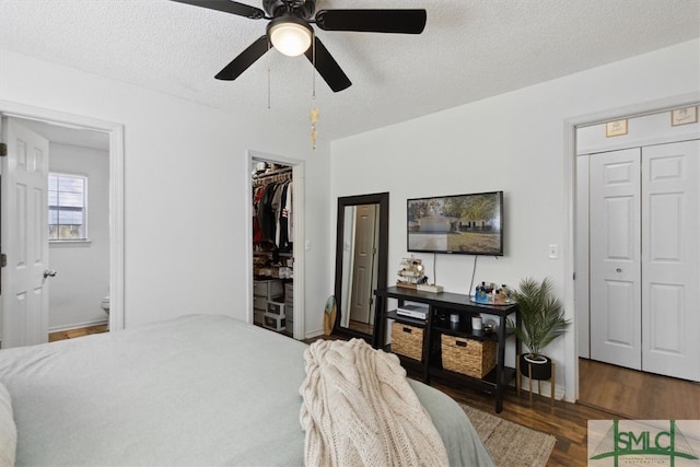 bedroom with ceiling fan, wood finished floors, a closet, and a textured ceiling