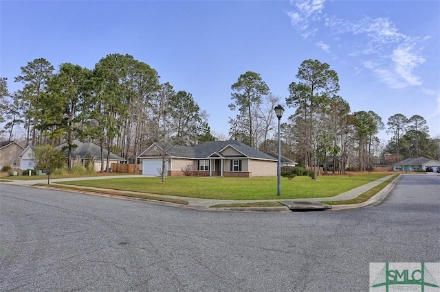 ranch-style home with a garage, concrete driveway, and a front yard