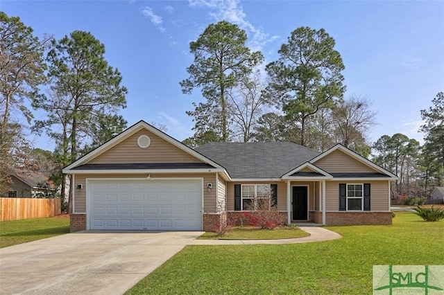 view of front of property with driveway, fence, a front yard, an attached garage, and brick siding