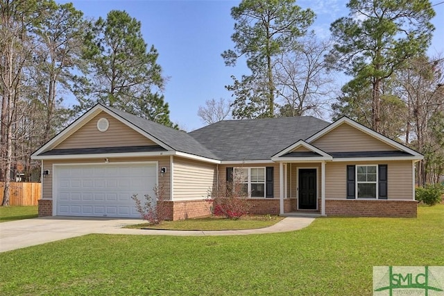 view of front of home featuring driveway, a front lawn, fence, an attached garage, and brick siding