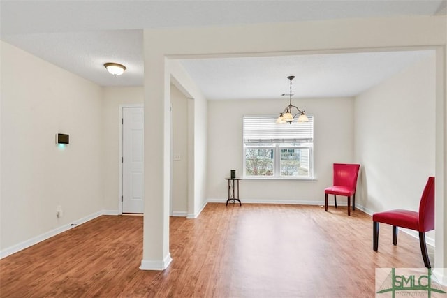 sitting room with light wood-style flooring and baseboards