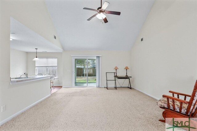 interior space featuring baseboards, visible vents, and high vaulted ceiling