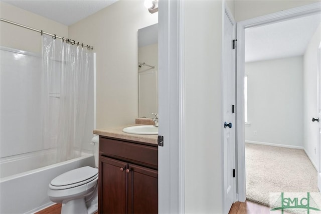 bathroom with baseboards, toilet, vanity, and shower / bath combination with curtain