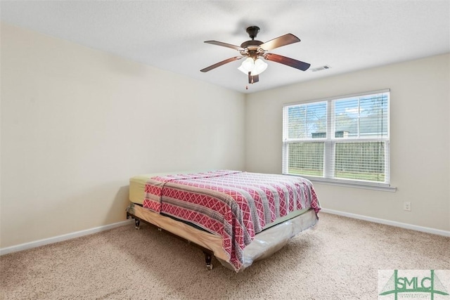 carpeted bedroom featuring visible vents, ceiling fan, and baseboards