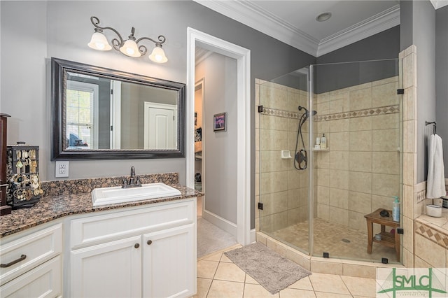 bathroom with tile patterned floors, a shower stall, vanity, and ornamental molding