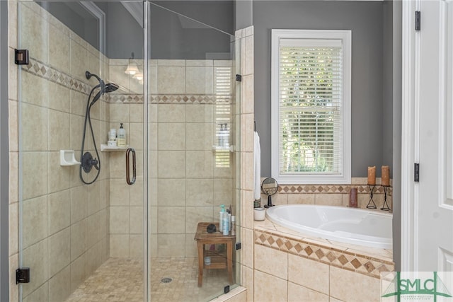 bathroom with a stall shower and a garden tub