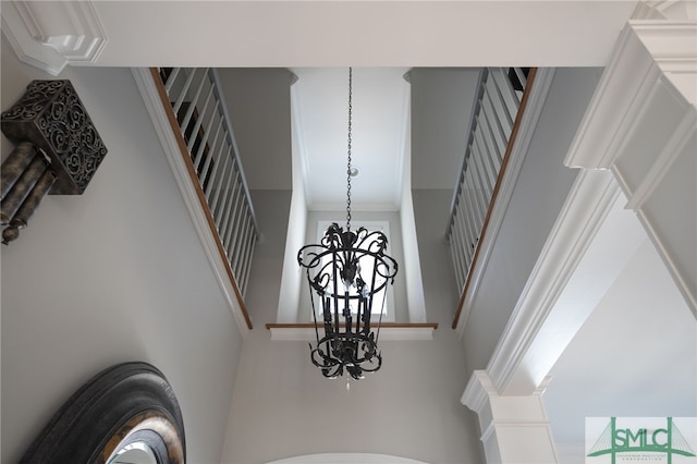 interior details with a chandelier and ornamental molding